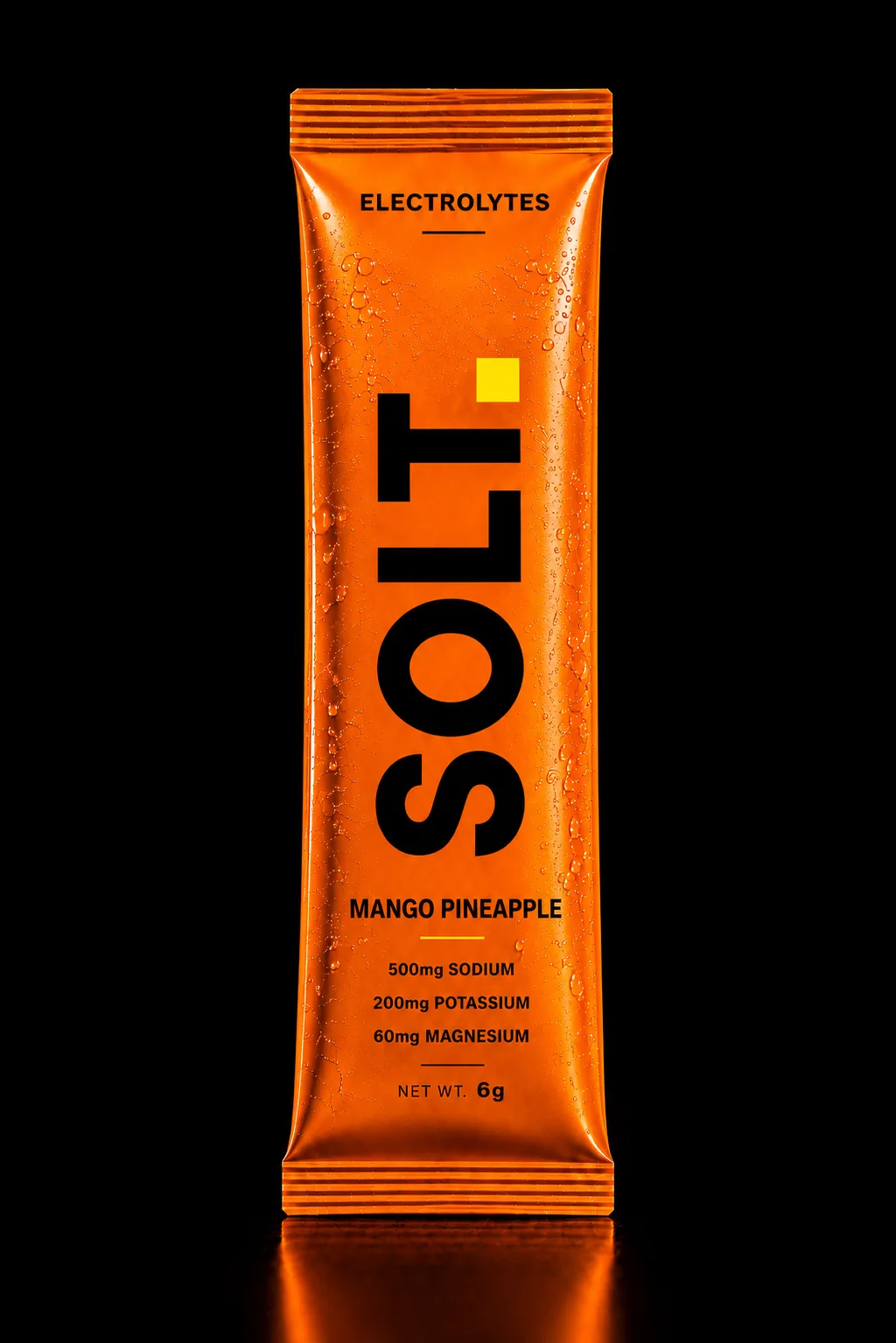 SOLT Mango Pineapple sachet, vivid orange pack on a dark stage. Real Himalayan salt, zero sugar.